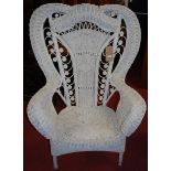 A white painted wicker peacock chair