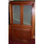 A mid-Victorian mahogany bookcase cabinet, the twin arch glazed upper doors over base fitted with