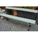 An early 20th century cast iron ended and painted pine (possibly railway) long waiting room bench,