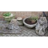 A reconstituted stone garden figure of a recumbent lion, together with a further garden statue of