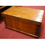 A late 19th century stained pine and metal bound hinged top tool chest, having iron end carry