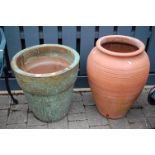 A contemporary glazed stoneware circular garden planter, together with a further terracotta baluster