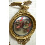 A Regency style gilt wood convex circular wall mirror, with perched eagle surmount, dia. 54.5cm