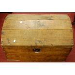 A rustic close nailed boarded pine domed and hinged top tool chest, with iron end carry handles, w.