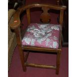 An early 19th provincial oak and elm corner elbow chair, with floral padded seat