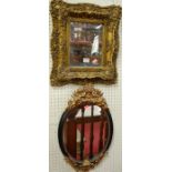 A contemporary floral gilt framed small bevelled wall mirror, together with a further oval cherub