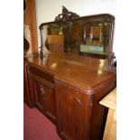 A mid-Victorian mahogany round cornered inverted breakfront mirror back sideboard, having cushion