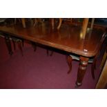 A Victorian mahogany round cornered extending dining table, having wind-out action and single