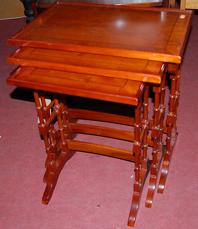 A reproduction yew wood nest of three occasional tables, the largest w.53cm