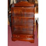 A contemporary mahogany bowfront waterfall open bookshelf, having single long lower drawer, w.63.