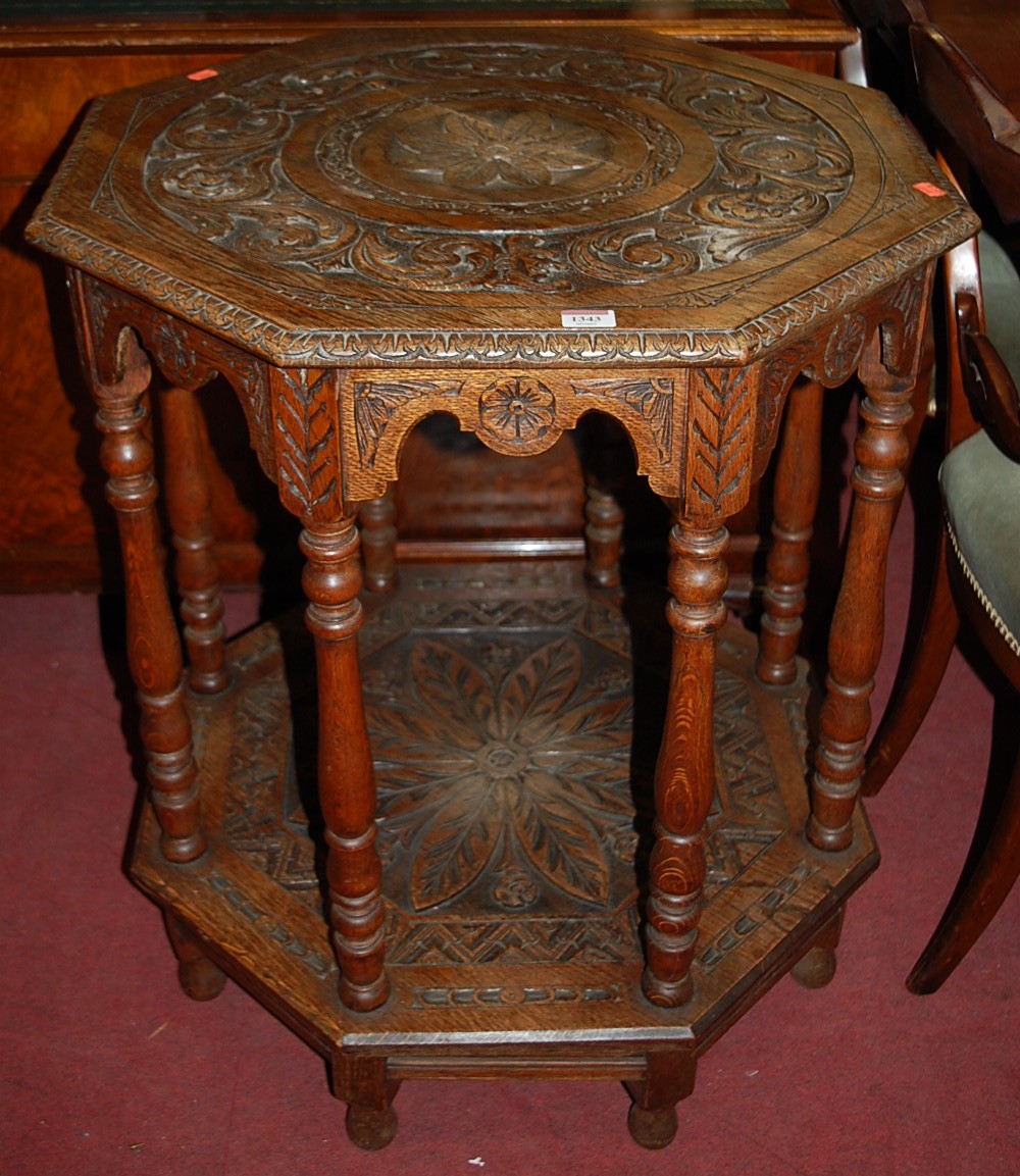 A circa 1900 carved oak two-tier occasional table