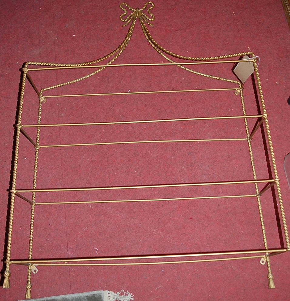 A gilt painted wirework four tier hanging wall shelf, having removable glass shelves, w.78cm