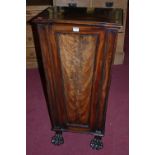 A George IV mahogany and flame mahogany pedestal side cupboard of tapering form on paw forelegs,
