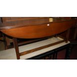 A mahogany dropleaf coffee table, raised on channelled supports, length 151cm