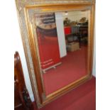 A contemporary large floral gilt decorated rectangular bevelled rectangular wall mirror, 153.5 x