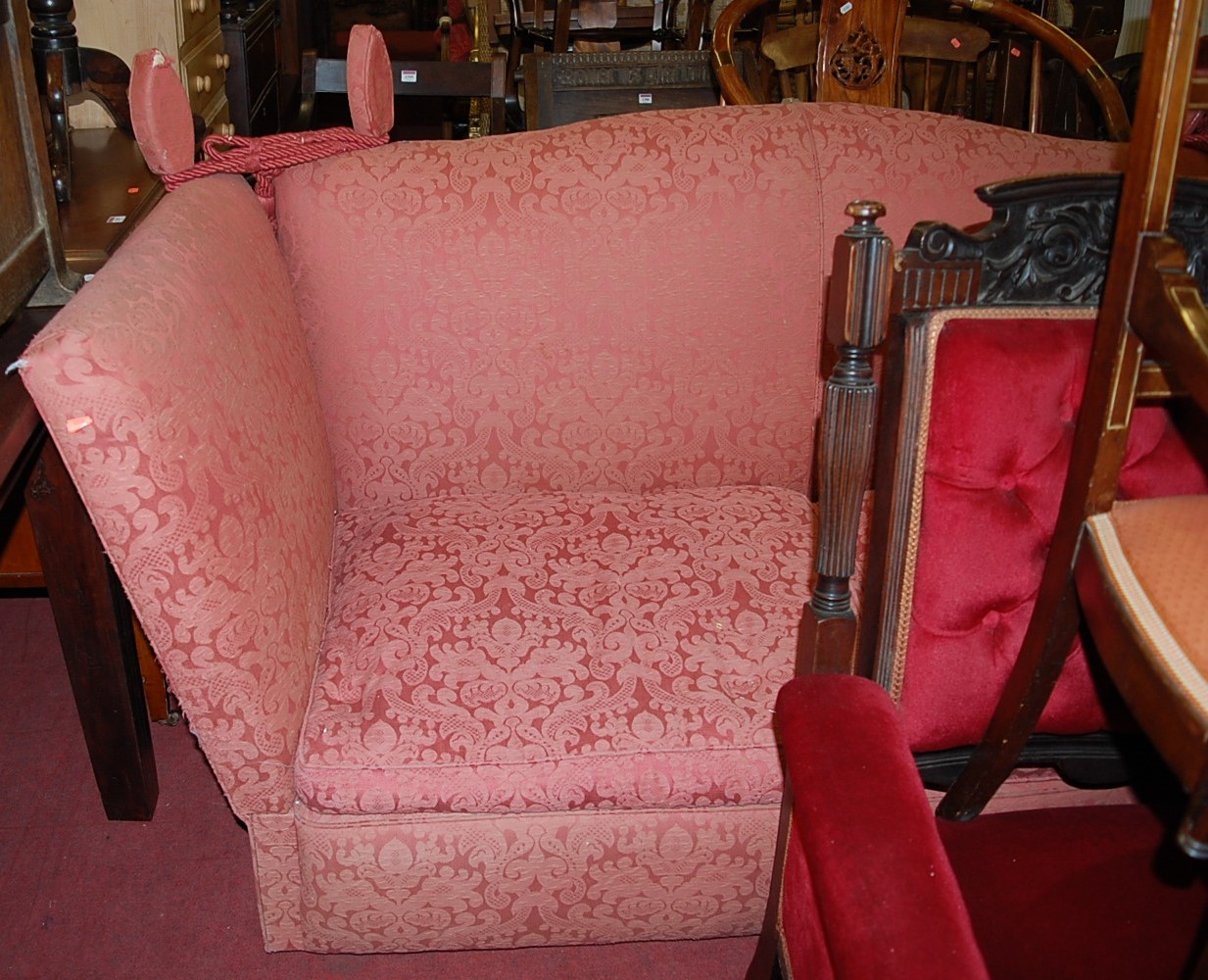 A red floral upholstered three-seater Knoll settee