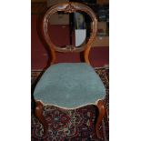 A set of four mid-Victorian walnut balloon back salon side chairs, each having upholstered stuff