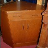 A 1970s G-Plan oak low double door corner cupboard having single frieze drawer