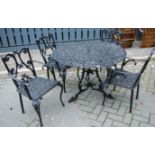 A Victorian style black painted, pierced and cast metal circular garden table, together with a set