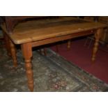 A Victorian style pine round cornered farmhouse kitchen table, having single end drawer and on