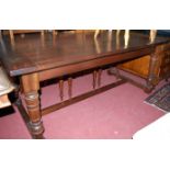 A walnut refectory table, having cleated ends and raised on ring turned and square cut supports