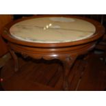 A contemporary mahogany and white variegated marble topped circular occasional table, on slender