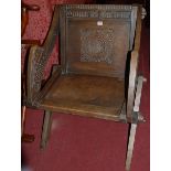 An early 20th century relief carved oak Glastonbury chair