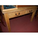 A 19th century pine round cornered two drawer kitchen table, on square block supports, w.135cm