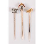 Three diamond set stick pins: a 9th Queen's Royal Lancers diamond and polychrome enamel stick pin,