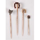 Four gemset stick pins: a diamond fox head stick pin, set with red hardstone eyes, 8mm wide; a 9ct