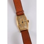 A gentleman's 18k gold Numa Watch Co. wristwatch, the signed rectangular barrel shaped dial, with