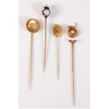 Four stick pins: to include a reverse painted intaglio stick pin, with a right arm in armour holding