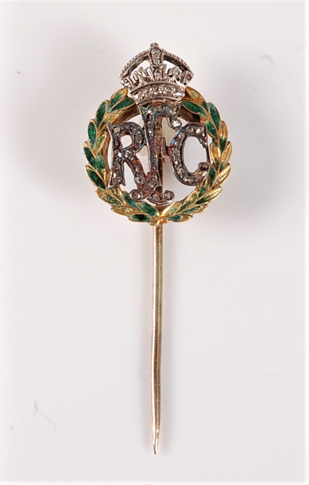 A Royal Flying Corps diamond stick pin: the green enamel wreath set to centre with RFC in small rose