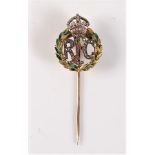 A Royal Flying Corps diamond stick pin: the green enamel wreath set to centre with RFC in small rose