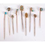 Nine stick pins: to include a 15ct diamond solitaire stick pin; a 9ct turquoise and seed pearl stick
