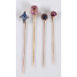 Four gemset stick pins: to include a pink topaz stick pin, approx. 6.9 x 9.6 x 5.6mm; a diamond