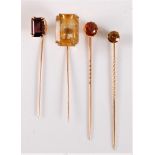 Four gemset stick pins: to include an andalusite stick pin, 6mm diameter; a hessonite garnet stick
