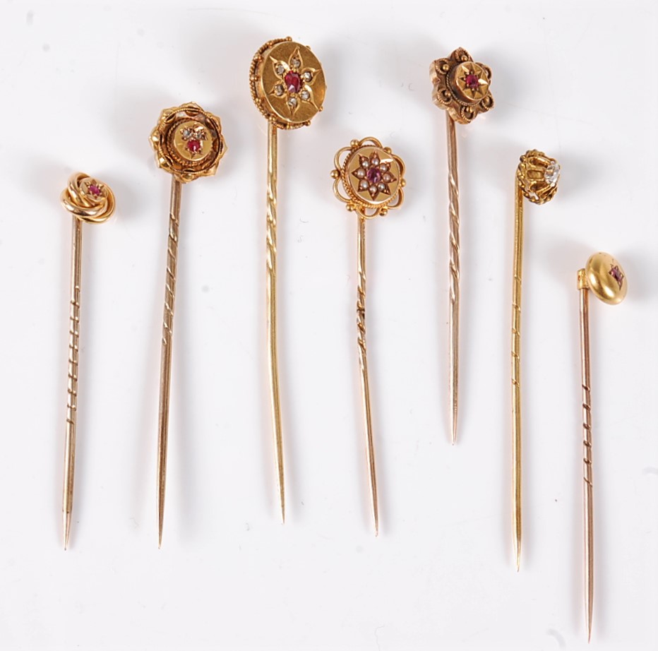 Seven ruby, diamond and pearl stick pins: an 18ct gypsy set ruby and seed pearl stick pin, 11mm