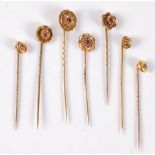 Seven ruby, diamond and pearl stick pins: an 18ct gypsy set ruby and seed pearl stick pin, 11mm