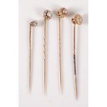 Four diamond and seed pearl stick pins: to include two pearl and diamond head flowerhead cluster
