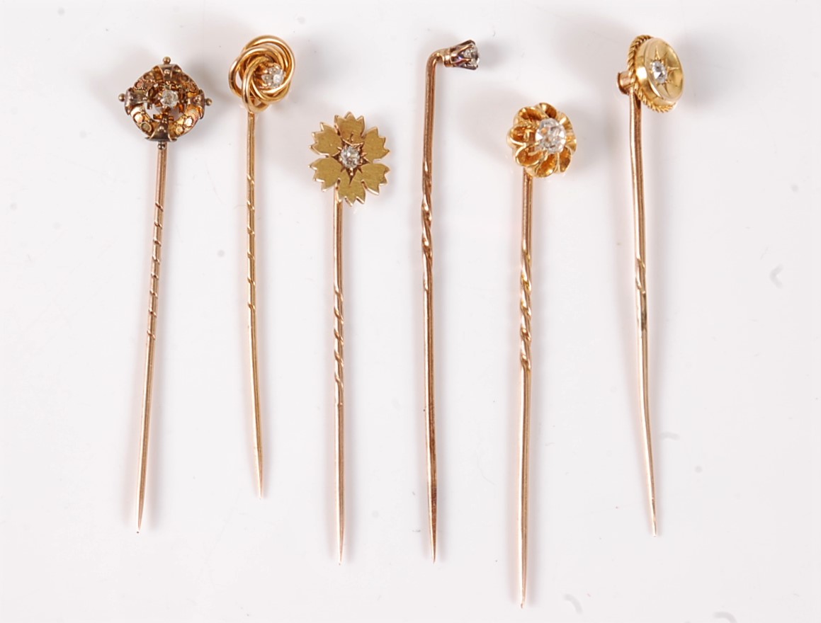 Six diamond set stick pins: an old cut diamond solitaire stick pin, estimated approx. 0.30cts, in