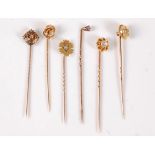 Six diamond set stick pins: an old cut diamond solitaire stick pin, estimated approx. 0.30cts, in