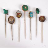 Eight various stick pins: to include a reverse painted stick pin of a dog, a printed stick pin of