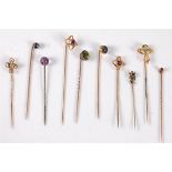 Ten gemset stick pins: a moss agate stick pin stamped '14'; an Art Nouveau style stick peridot stick