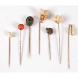 Seven stick pins: a stags tooth stick pin, the two teeth set as an acorn among oak leaves, 18mm