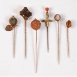 Six various stick pins: to include a Celtic cross stick pin; a stick pin set with a round seed; an