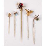 Five insect stick pins: a garnet spider stick pin, 23 x 20mm; a peridot and seed pearl fly stick