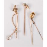 Three pearl stick pins: a seed pearl and turquoise set frog stick pin, 14mm wide, stamped '15' to