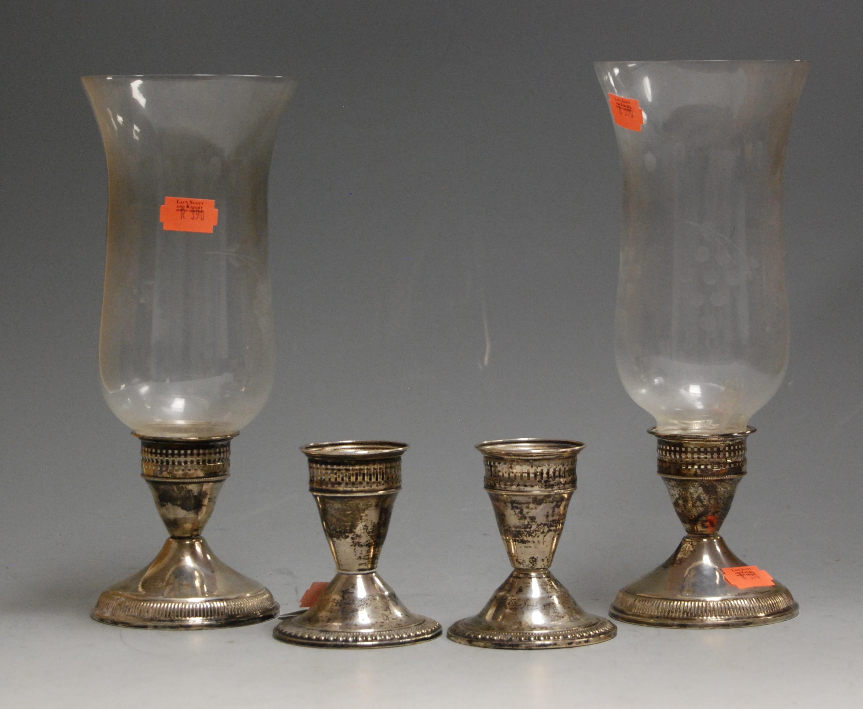 A pair of 20th century sterling silver dwarf table candlesticks each having clear glass bell