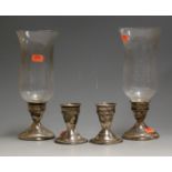 A pair of 20th century sterling silver dwarf table candlesticks each having clear glass bell